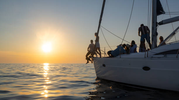 istock People relaxing on yacht and watching colourful sunset 1390170473
