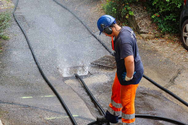 sewer cleaning and worker with water and hose in pipe stock photo