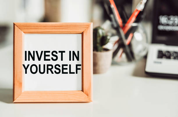 istock Wooden frame with office background with text invest in yourself. 1390170914