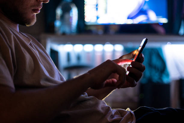 istock person holding smartphone and scrolling on web page at night 1390174544