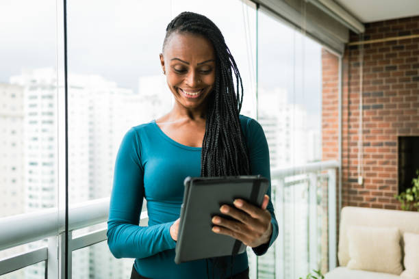 istock A young woman smilingly looks at her tablet 1390184781