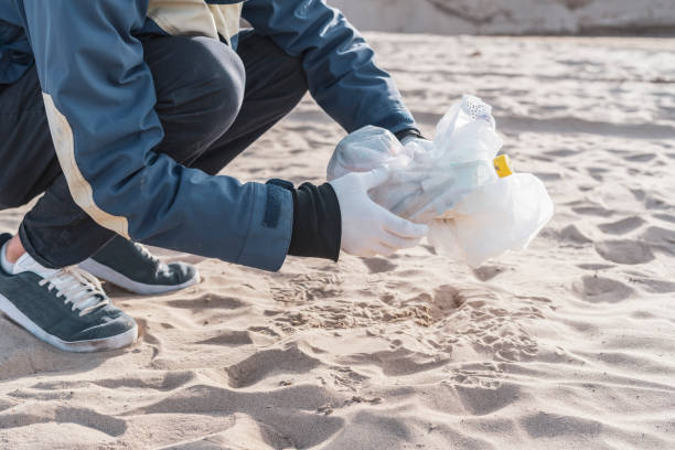 istock global environment problems conversation, person holding garbage outdoors, cleaning our ecosystem 1390185724