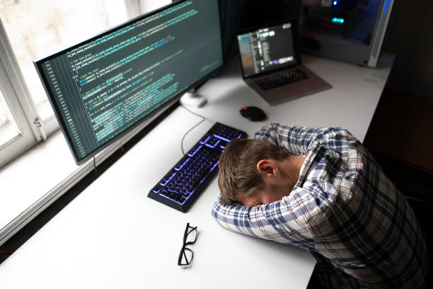 istock male employee lying on the table, sleep at work, overworking crunch time concept 1390185736