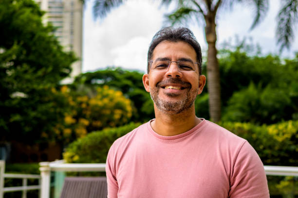 istock A mature man in glasses smiles happily 1390186411