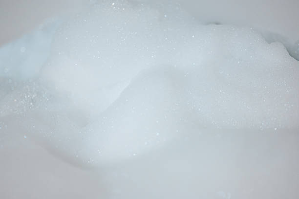 istock Close up shot Air bubbles moving bubble bath on rough surface in background 1390188073