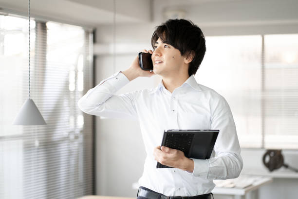 istock Asian man making phone calls in the office 1390194759