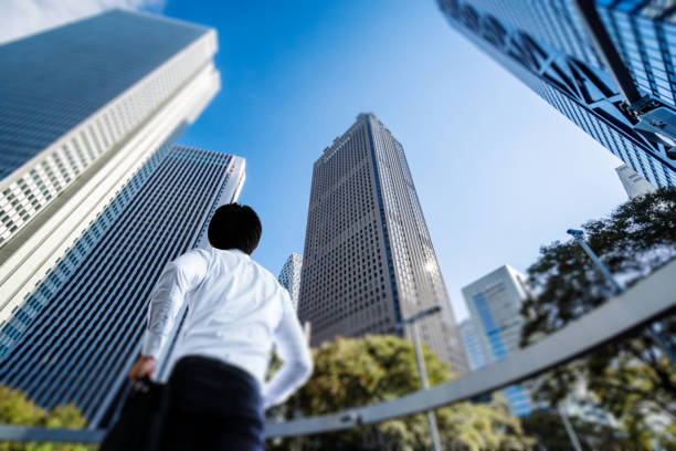 Asian businessman walking in the office district stock photo