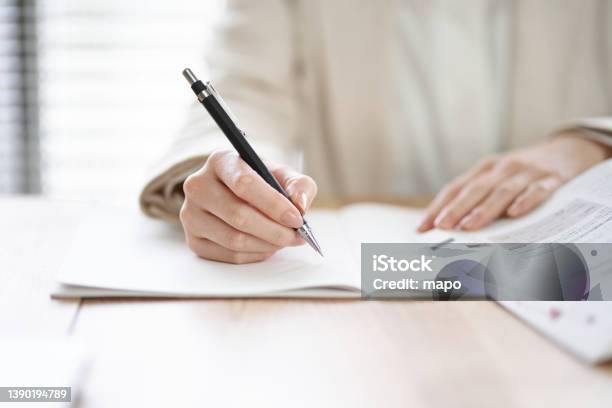 Hands Of An Asian Woman Studying In A Coworking Space Stock Photo - Download Image Now