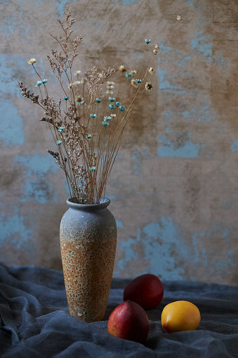 still life: fruits, dry flowers and retro-style vase