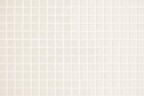 istock Beige ceramic wall and floor tile abstract background. Design geometric gray mosaic texture decoration of the bedroom. Simple seamless pattern grid for backdrop hospital wall, canteen and kitchen. 1390199904