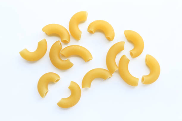 istock Pile of raw macaroni isolated on white background. 1390200001