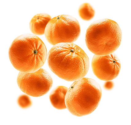 Orange tangerines levitate on a white background.