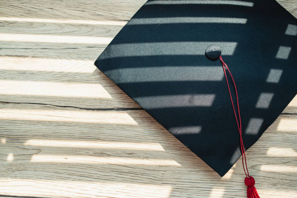 istock Black graduation cap University level, placed on a wooden table, concept, graduation 1390206687