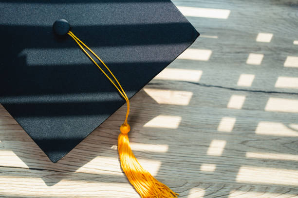istock Black graduation cap University level, placed on a wooden table, concept, graduation 1390206693