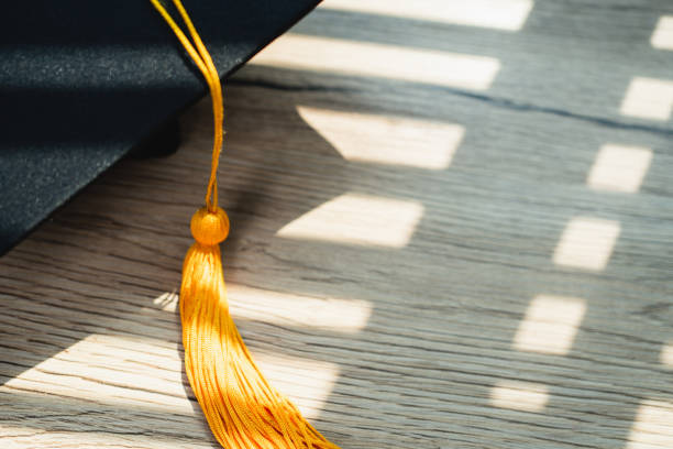 istock Black graduation cap University level, placed on a wooden table, concept, graduation 1390206695