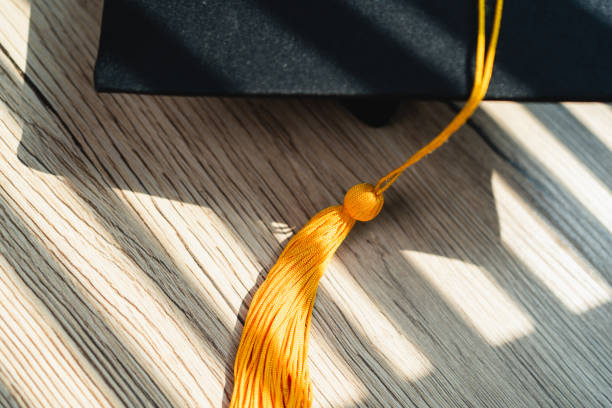 istock Black graduation cap University level, placed on a wooden table, concept, graduation 1390206701