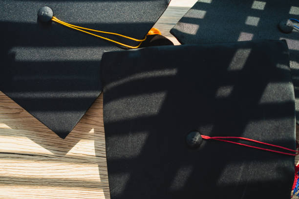 istock Black graduation cap University level, placed on a wooden table, concept, graduation 1390206703