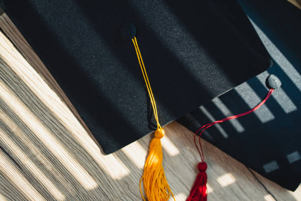 istock Black graduation cap University level, placed on a wooden table, concept, graduation 1390206709