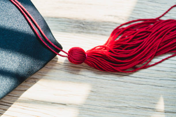 istock Black graduation cap University level, placed on a wooden table, concept, graduation 1390206717