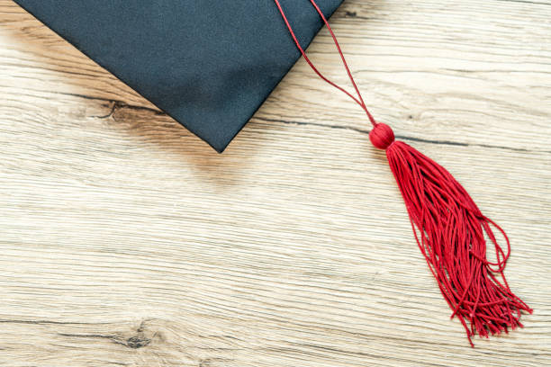 istock Black graduation cap University level, placed on a wooden table, concept, graduation 1390206772