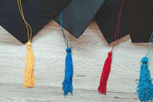 istock Black graduation cap University level, placed on a wooden table, concept, graduation 1390207301
