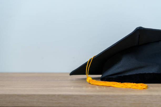 istock Black graduation cap University level, placed on a wooden table, concept, graduation 1390207511