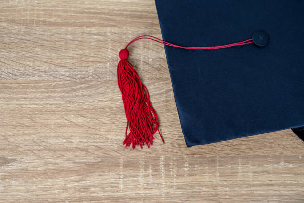 istock Black graduation cap University level, placed on a wooden table, concept, graduation 1390207552