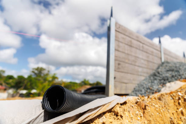 istock Drainage pipes behind concrete sleeper retaining wall - shallow depth of field 1390208672