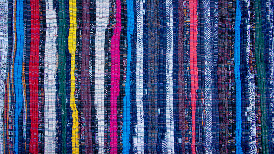 Colorful vertical lines weave fabric texture background. Multicolor woven textile art design pattern with rough surface