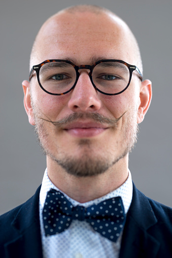 Hipster styled portrait a young man, studioshot with tilt shift lens