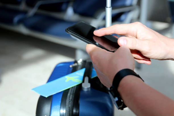 istock Passenger is  waiting the delayed  flight at the airport. Man is texting the message on a  mobile phone 1390211366
