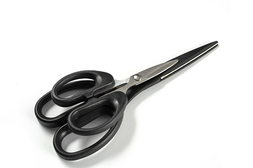 Scissors on white background board