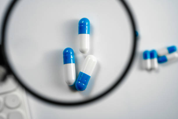capsules and tablet on a plain background