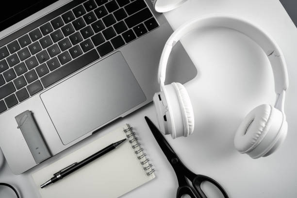 istock Computer, magnifying glass, glasses, notebook and headset on white background board 1390212494