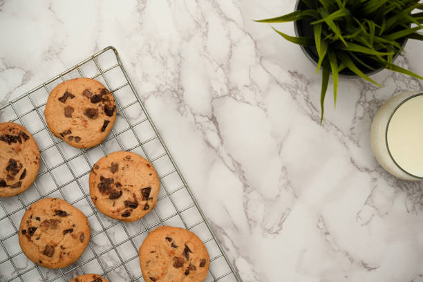 istock Top view, Flat lay, Freshly baked chocolate chip cookies on a wire cooling rack 1390213623