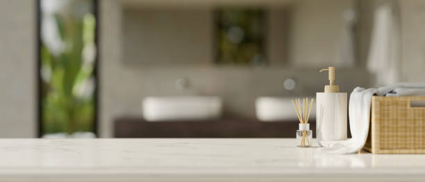 white tabletop with copy space against blurred modern comfortable bathroom interior - hotel shampoo stockfoto's en -beelden