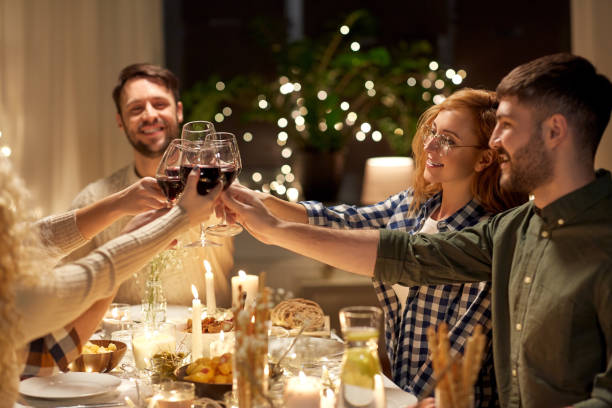 istock happy friends drinking red wine at christmas party 1390214065