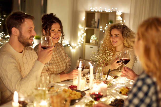 istock happy friends drinking red wine at christmas party 1390214085