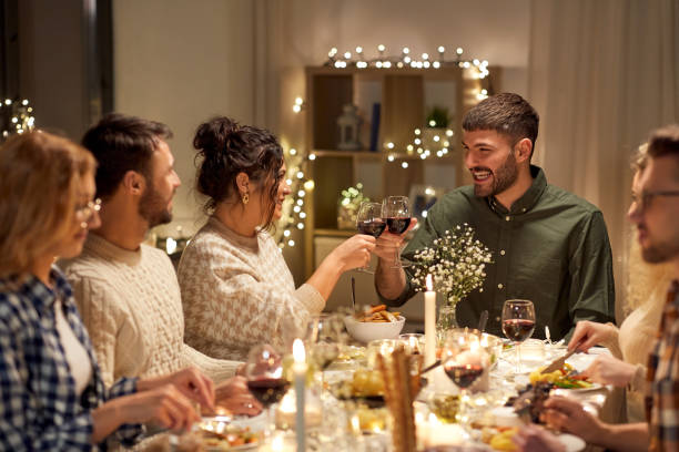 istock happy friends drinking red wine at christmas party 1390214616