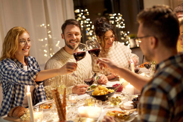 istock happy friends drinking red wine at christmas party 1390214662