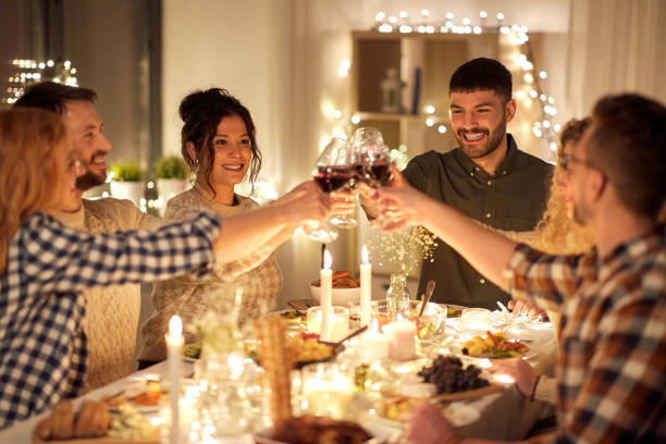 istock happy friends drinking red wine at christmas party 1390214800