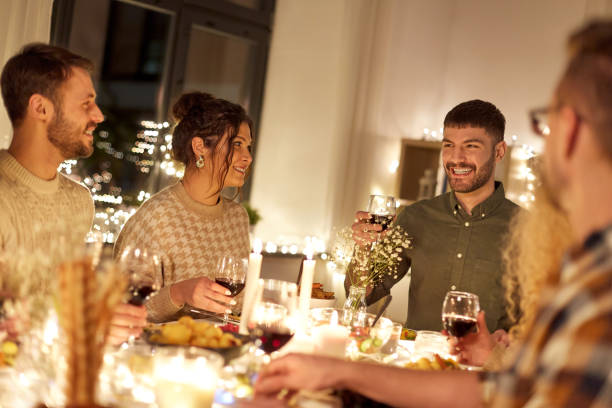 istock happy friends drinking red wine at christmas party 1390214943