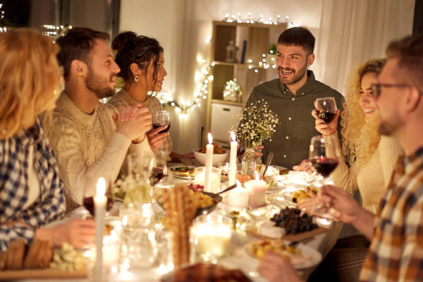 istock happy friends drinking red wine at christmas party 1390215032