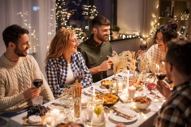 istock happy friends drinking red wine at christmas party 1390215879