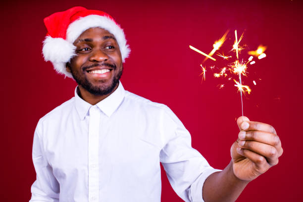 istock african american man holding a burning stick of dynamite in studio red background 1390215914