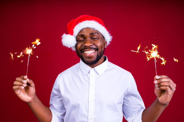 istock african american man holding a burning stick of dynamite in studio red background 1390215916