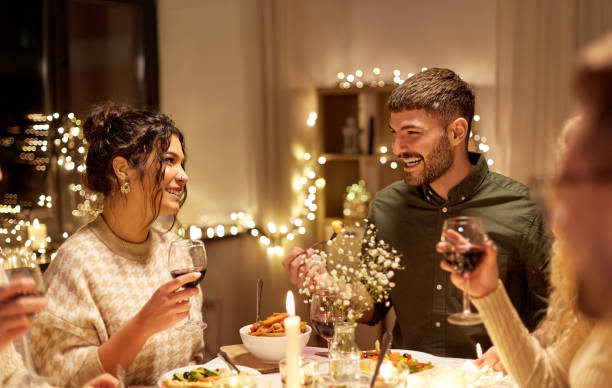 istock happy friends drinking red wine at christmas party 1390216084