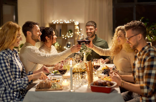 istock happy friends drinking red wine at christmas party 1390216340