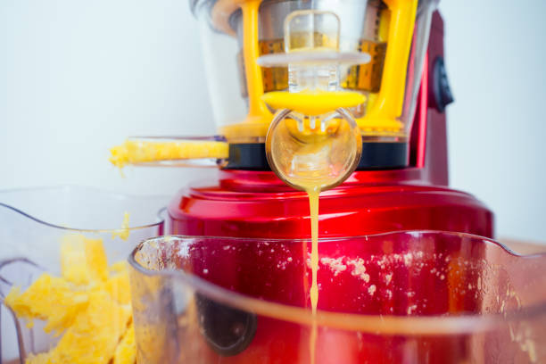 istock raw food diet concept oranges and juicemachine in white background 1390216372