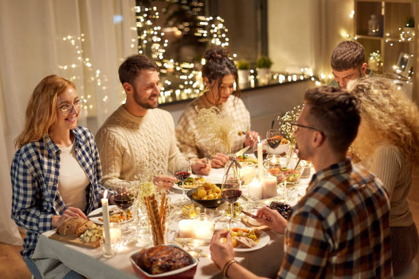 istock happy friends having christmas dinner at home 1390216526